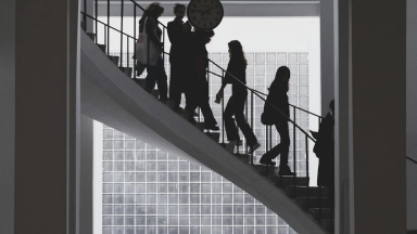 corporate-a-group-of-people-walking-up-a-staircase-